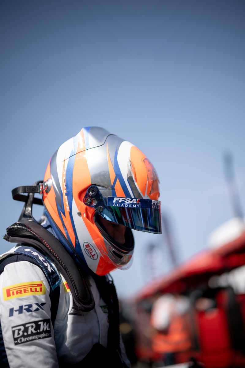 Jack Iliffe in helmet, profile view with bokeh background